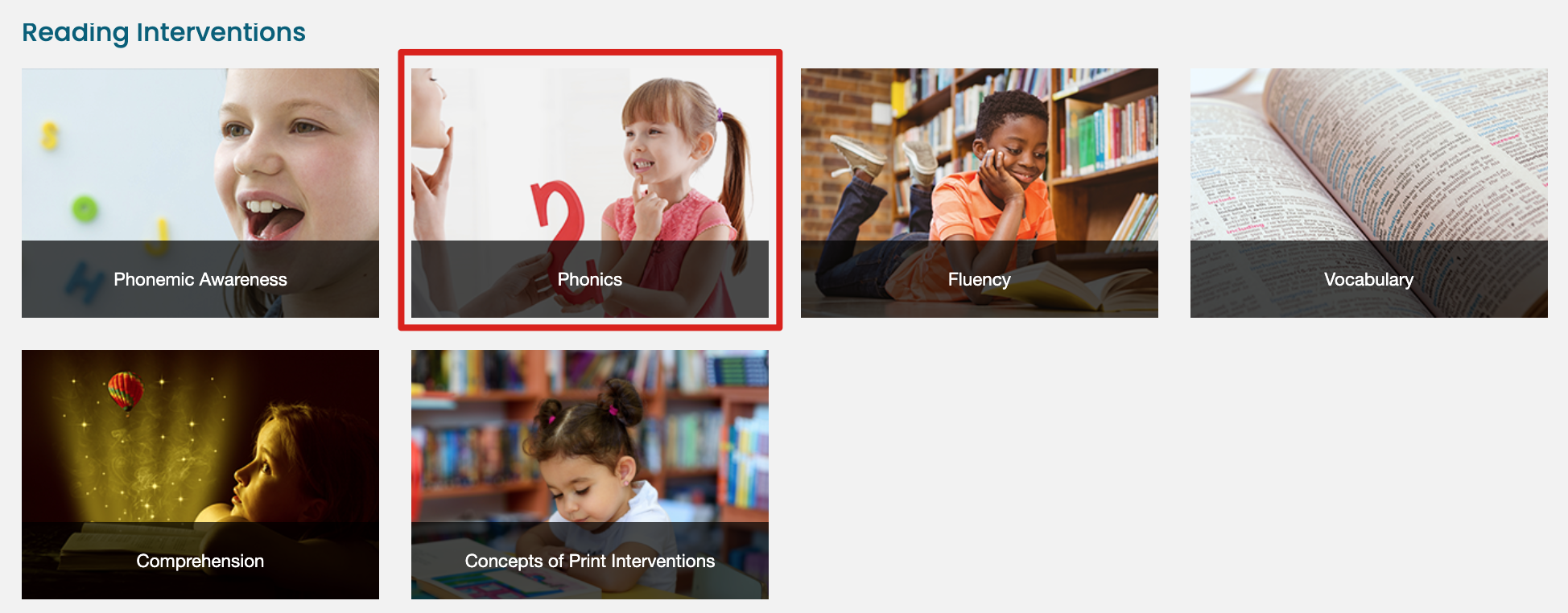 A grid of six categories for reading interventions. The top row includes: 'Phonemic Awareness' with an image of a child smiling, 'Phonics' (highlighted with a red border) showing a young girl holding a letter and smiling, and 'Fluency' with an image of a boy reading a book in a library. The bottom row includes: 'Vocabulary' with an image of an open dictionary, 'Comprehension' featuring a child looking at a glowing hot air balloon emerging from a book, and 'Concepts of Print Interventions' with an image of a young girl reading in a library